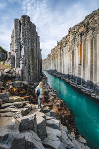 Rear view of woman walking on rocks