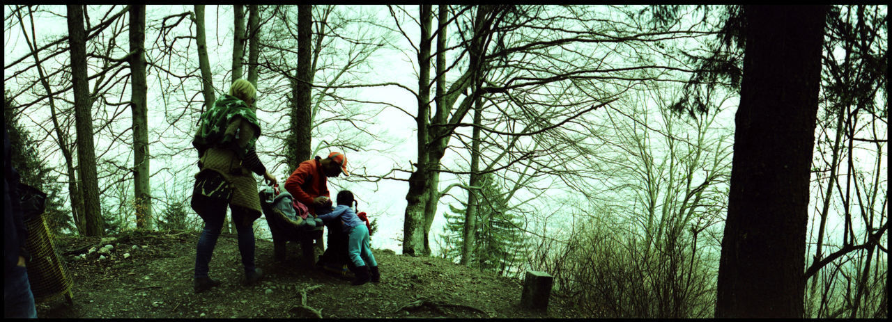 WOMAN WITH ARMS RAISED IN FOREST