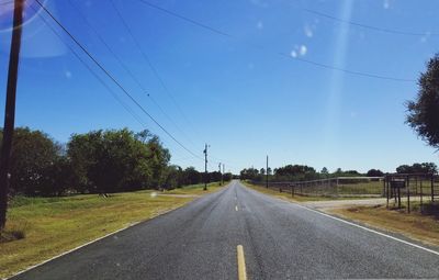 Road amidst trees against sky