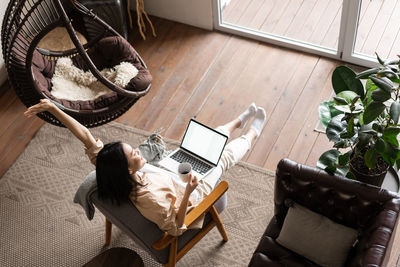 High angle view of woman sitting on chair