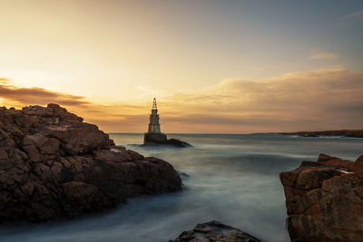 Sunrise at the lighthouse in ahtopol, bulgaria.