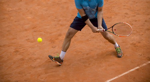 Low section of player playing tennis