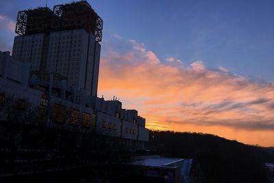 Low angle view of buildings against sky during sunset