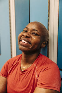 Portrait of smiling female athlete in locker room