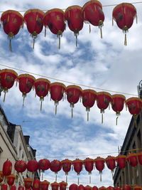 Low angle view of lanterns hanging against sky