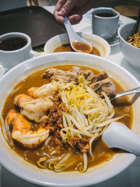 Cropped hand of person preparing food