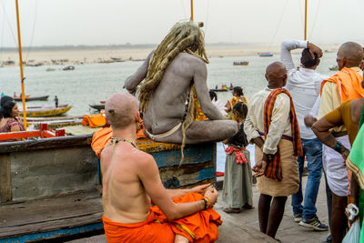 Rear view of people on boat in sea