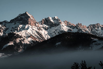 Scenic view of snowcapped mountains against clear sky