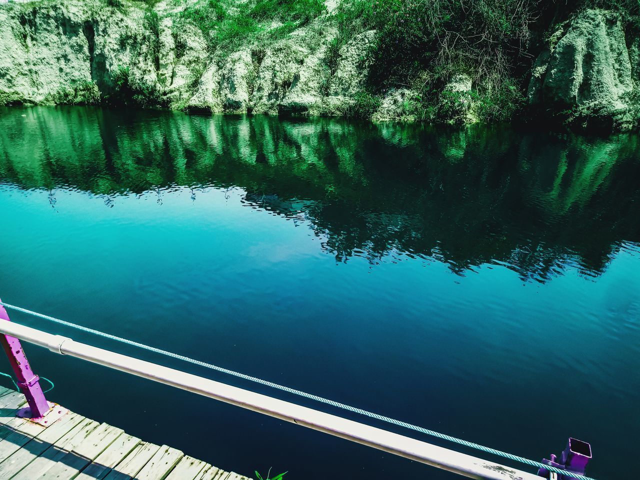 HIGH ANGLE VIEW OF REFLECTION OF TREES IN LAKE