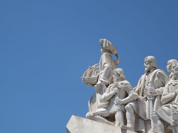 Low angle view of statue against clear blue sky