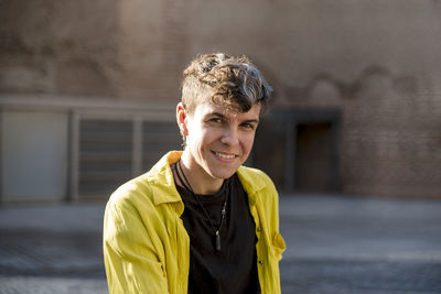 Portrait of a non binary person looking at camera while posing outdoors. person