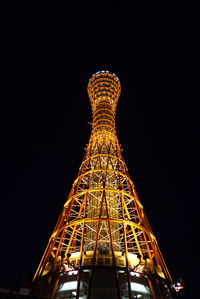 Low angle view of illuminated ferris wheel against sky at night