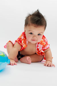 Portrait of cute baby against white background