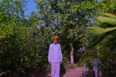 Portrait of man standing against plants