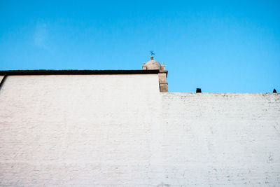 Low angle view of building against clear blue sky