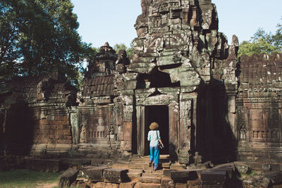 Rear view full length of woman entering temple