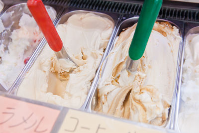 High angle view of ice cream in containers at store for sale