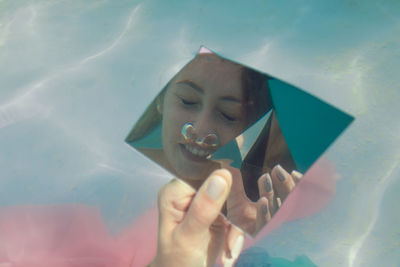 Reflection of woman in mirror underwater