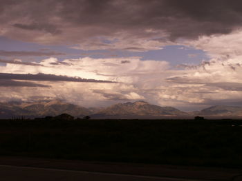 Scenic view of mountains against cloudy sky