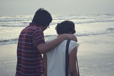 Rear view of couple on beach