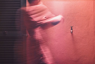 Close-up of hands against wall