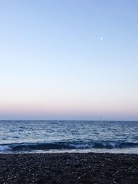 Scenic view of sea against clear sky at night