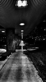 Walkway in illuminated tunnel