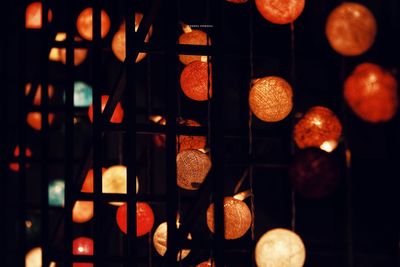 Low angle view of illuminated lights hanging at night