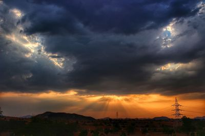 Storm clouds over city at sunset