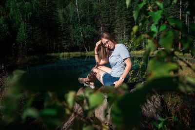 Woman sitting in forest