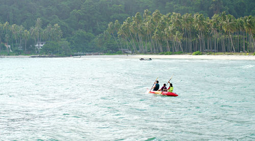 People in boat on sea