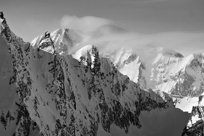 Scenic view of snow covered mountains against sky