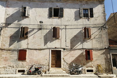 Low angle view of building windows and shutters 
