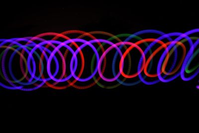 Close-up of illuminated light bulbs against black background