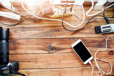 High angle view of mobile phone on wooden table