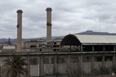 Abandoned factory against sky