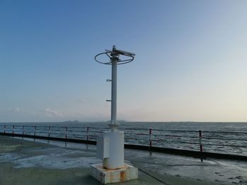 Street light on beach against clear sky
