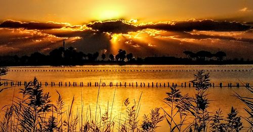 Scenic view of lake against sky during sunset