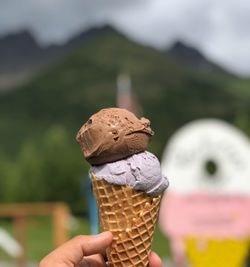 Close-up of hand holding ice cream cone