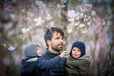 Portrait of young couple standing in park during winter
