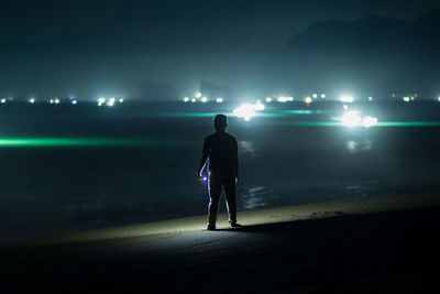 Dreamy of man on beach at night