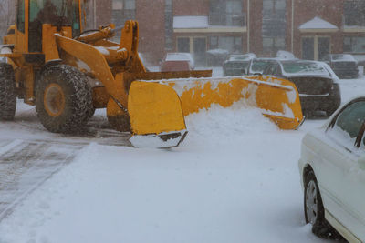 Snow covered car on road