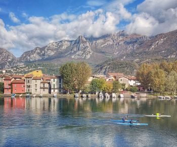 Scenic view of lake by buildings against sky