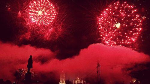 Low angle view of firework display at night