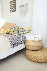 Close-up of wicker basket on bed at home