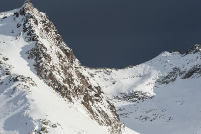 Scenic view of snowcapped mountains against clear sky