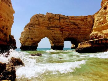 Scenic view of sea and rock formation against sky