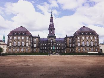 Scenic view of christiansborg palace against cloudy sky