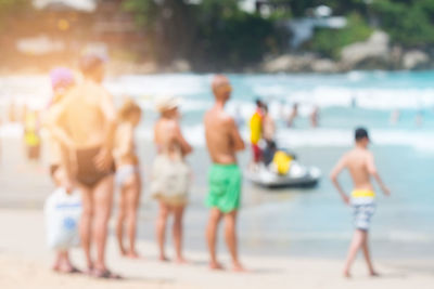 People at beach during sunny day