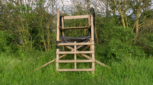 Wooden chair on green landscape